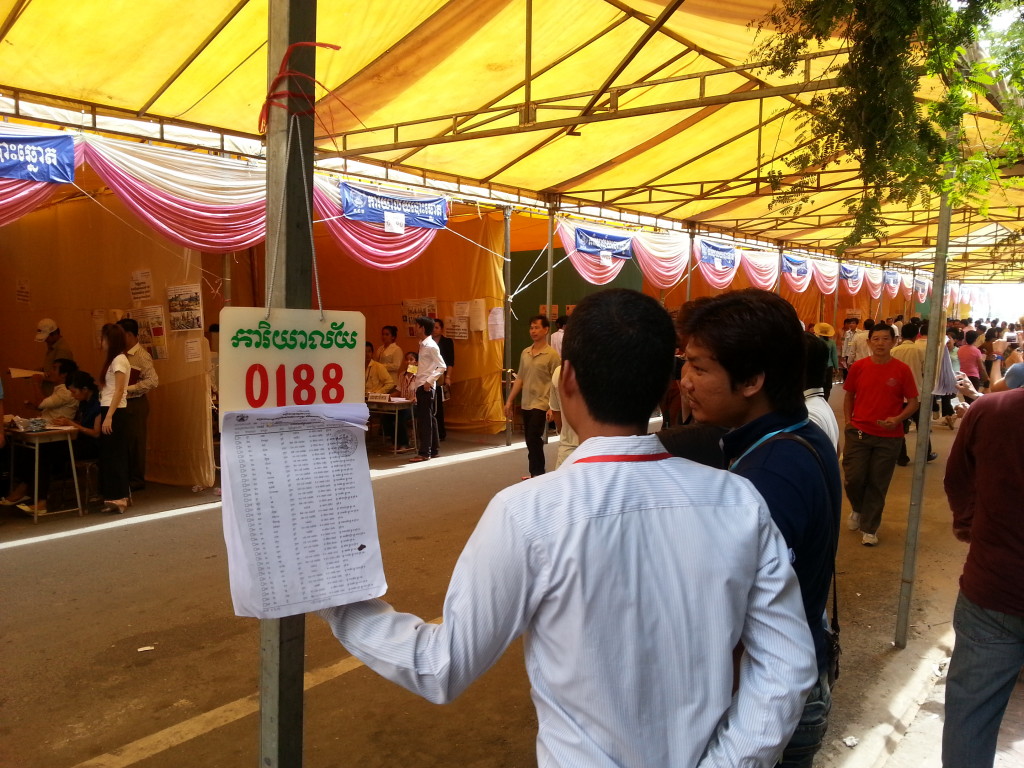 Election monitors keep an eye on the voting Sunday morning on Street 130 near Phnom Penh's riverside.