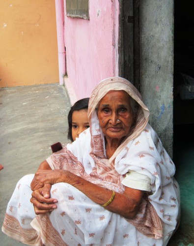 An old woman and her grand daughter rest in a safe place amid the flooded streets of Varanasi.