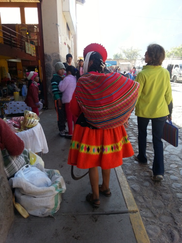Two women - one traditional Peruvian and one (Gabi) traditional traveler, contrast near the mercado in Ollantaytambo