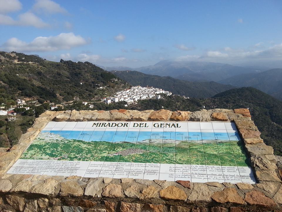 A mural shows the mountain peaks of the Genal Valley. In the background, one of the countless white villages of Andalusia