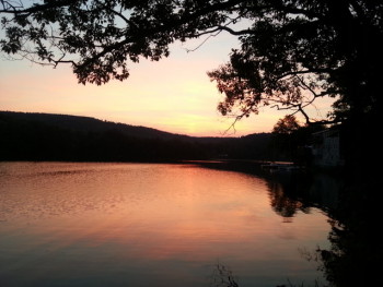 Sunset washes over the calm waters of Ashfield Lake