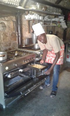 Man at work: Simon pops a tray of roasted hake being prepared for tonight's starter at the Kapika Lodge.